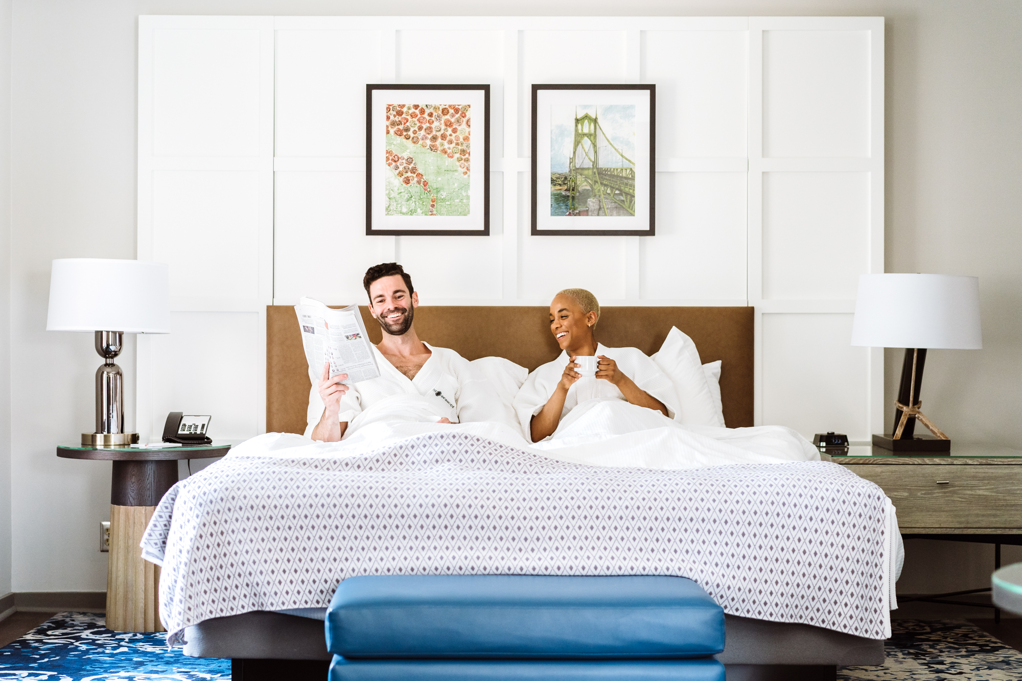A couple having coffee and reading the paper in bed.