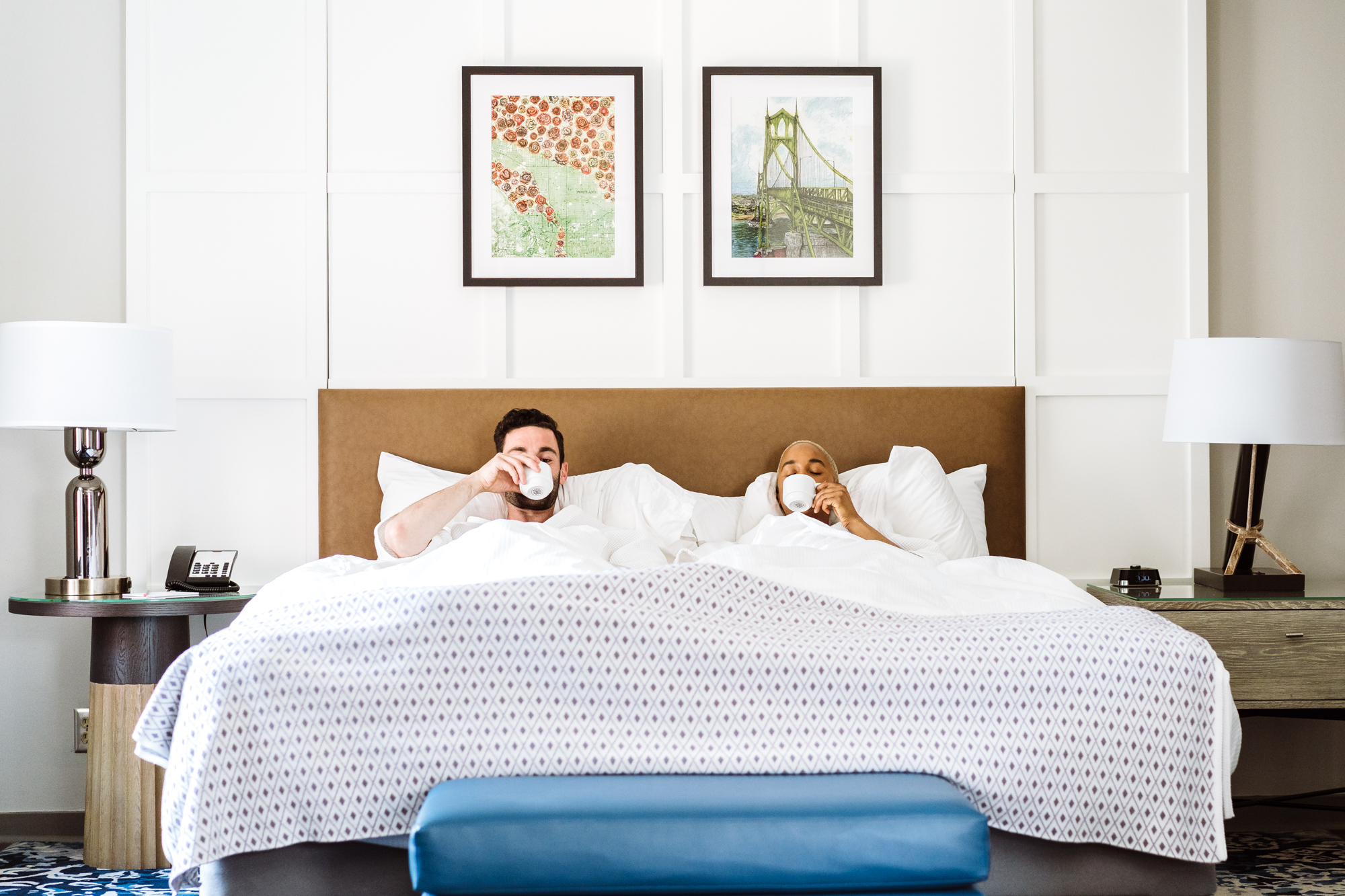 A couple having coffee in bed at the Heathman Hotel in Portland, Oregon.