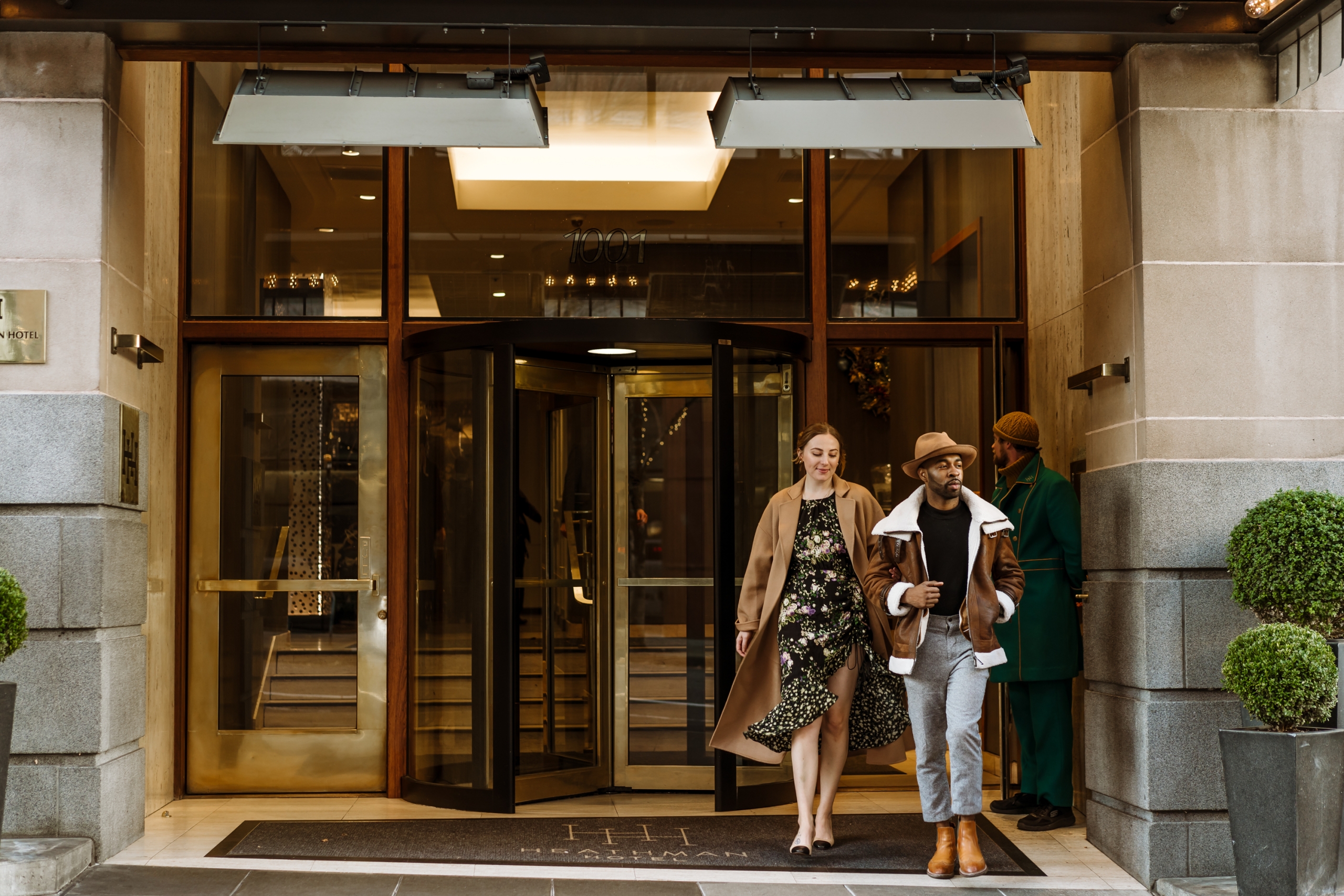 couple exiting the front door of the Heathman Hotel