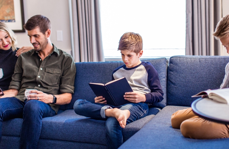 Lovely couple with two boys reading books